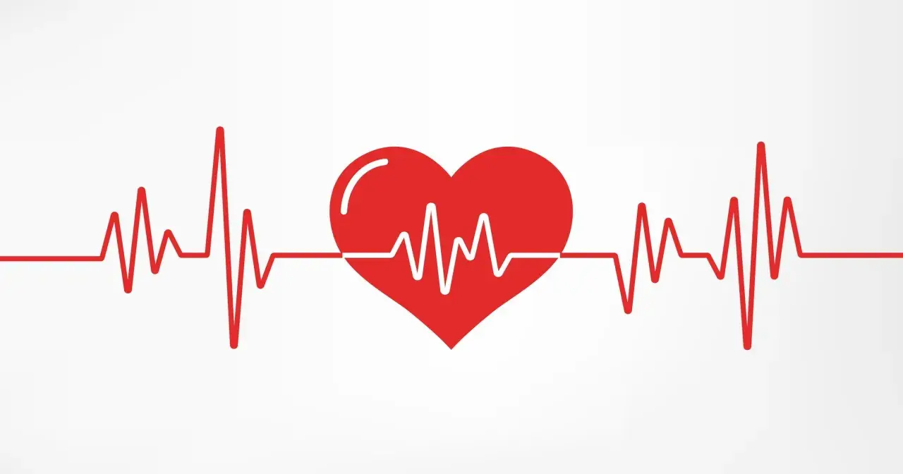 Czerwone serce z linią EKG na białym tle.